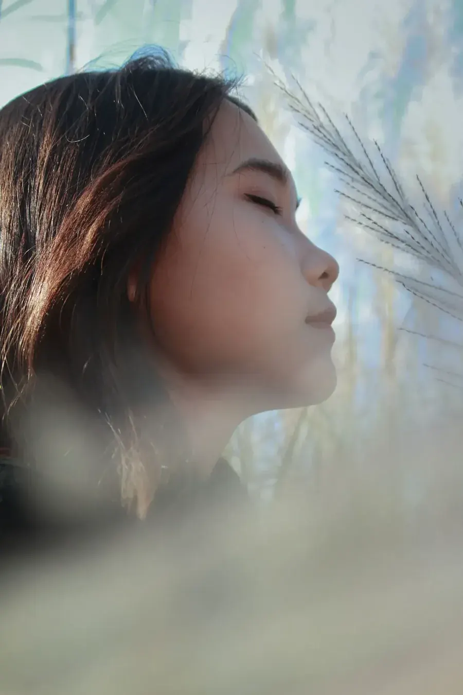 A woman turning her face into the wind, breathing air that belongs to no one.