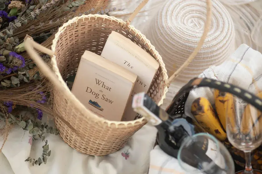 Books and dried flowers gathered in a basket, an afternoon nobody had to earn.