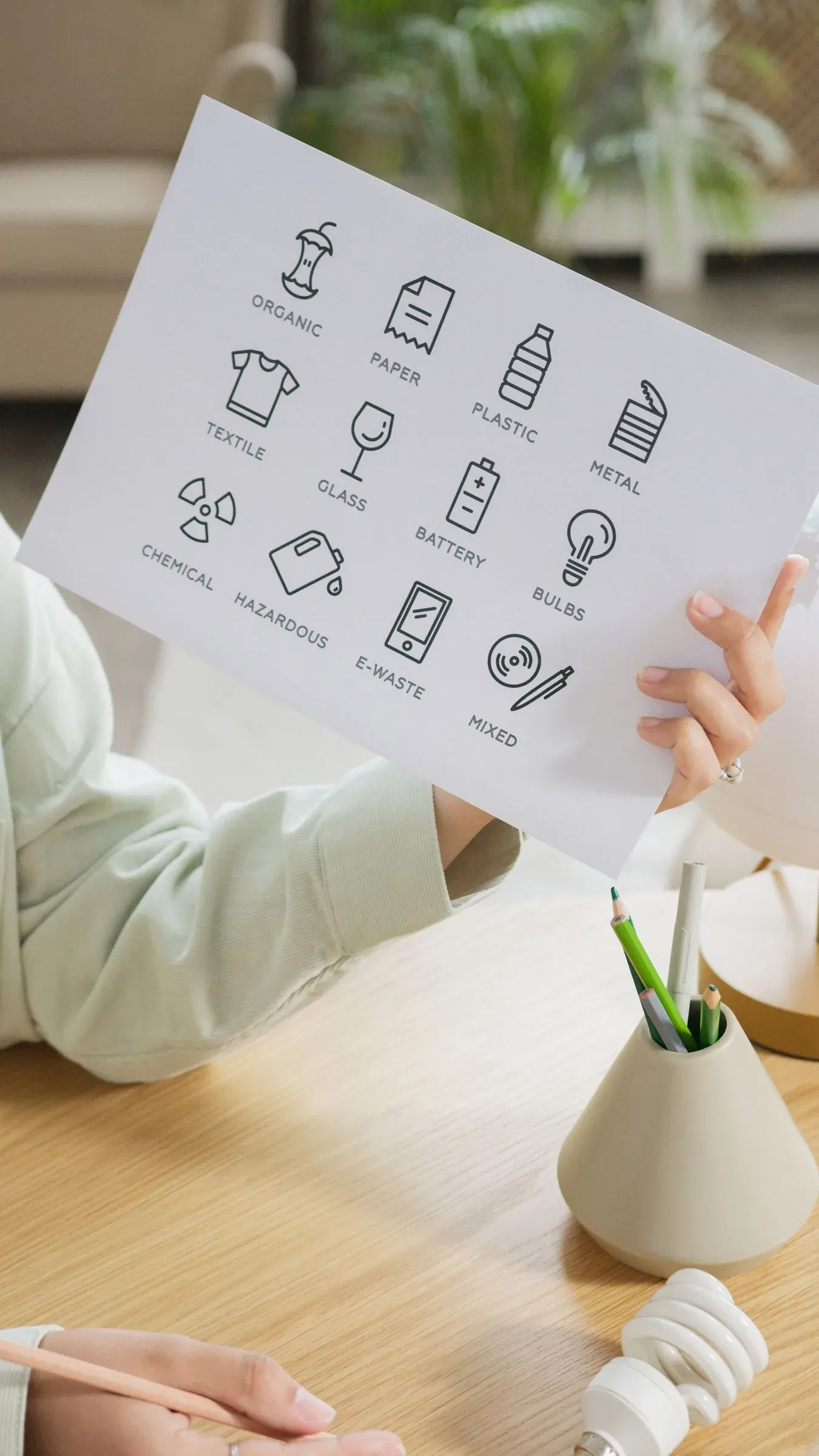 A sorting chart held up in two hands, small admin that quietly matters.