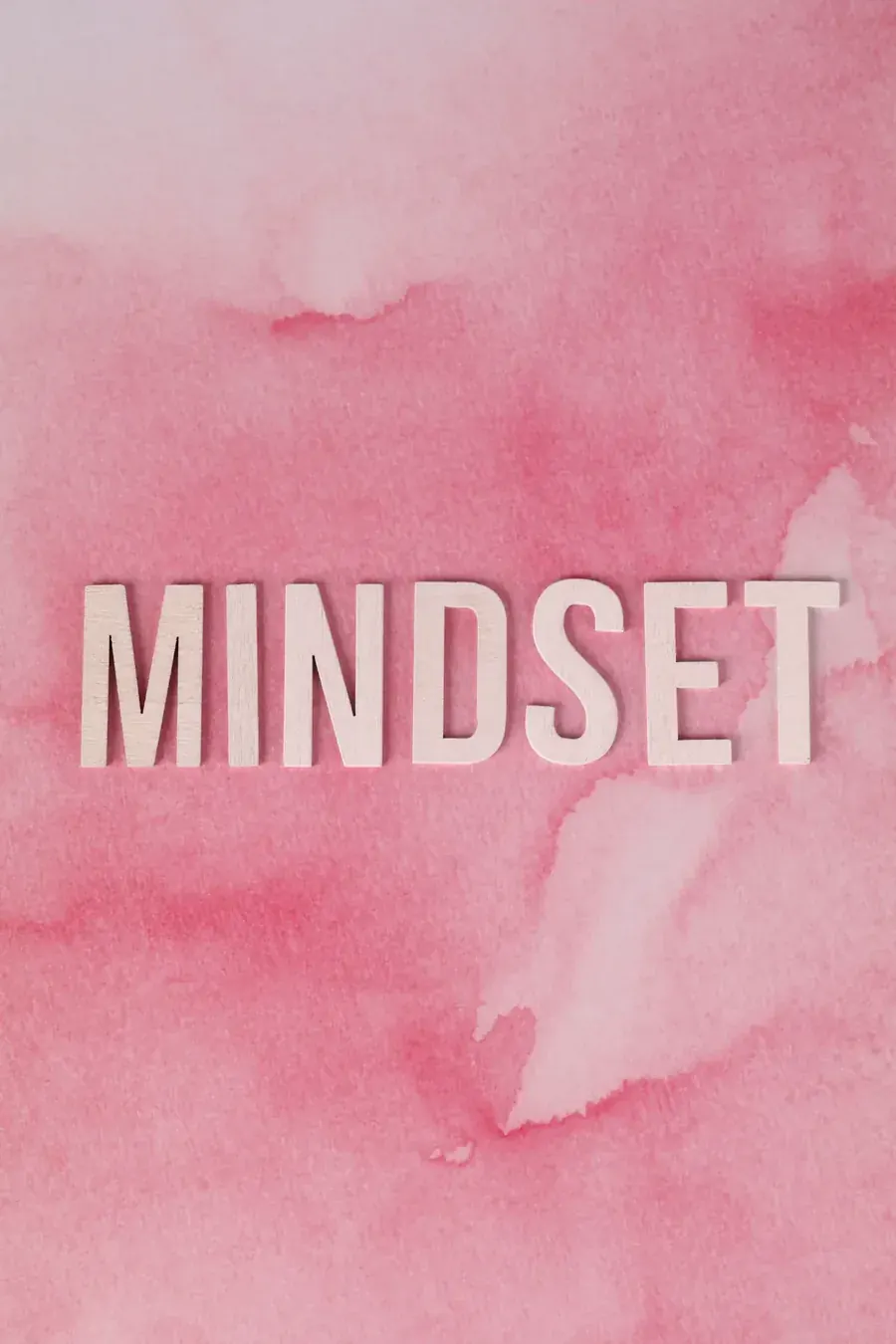 The word MINDSET on soft pink, a sentence repeated until it starts to hold.