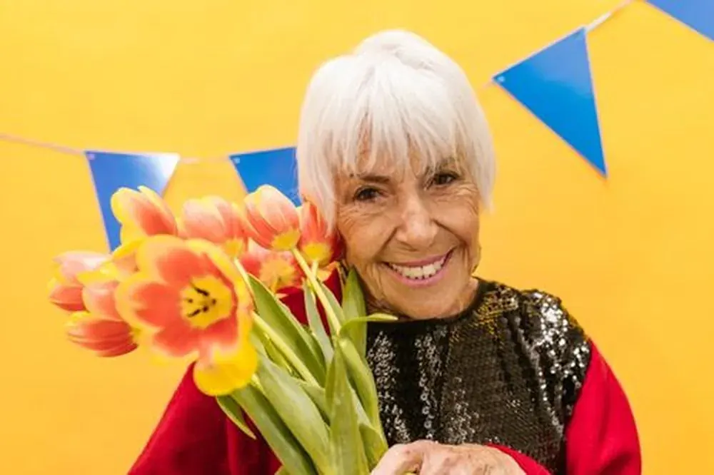 An older woman holding tulips and filling the whole frame, no apology in it.