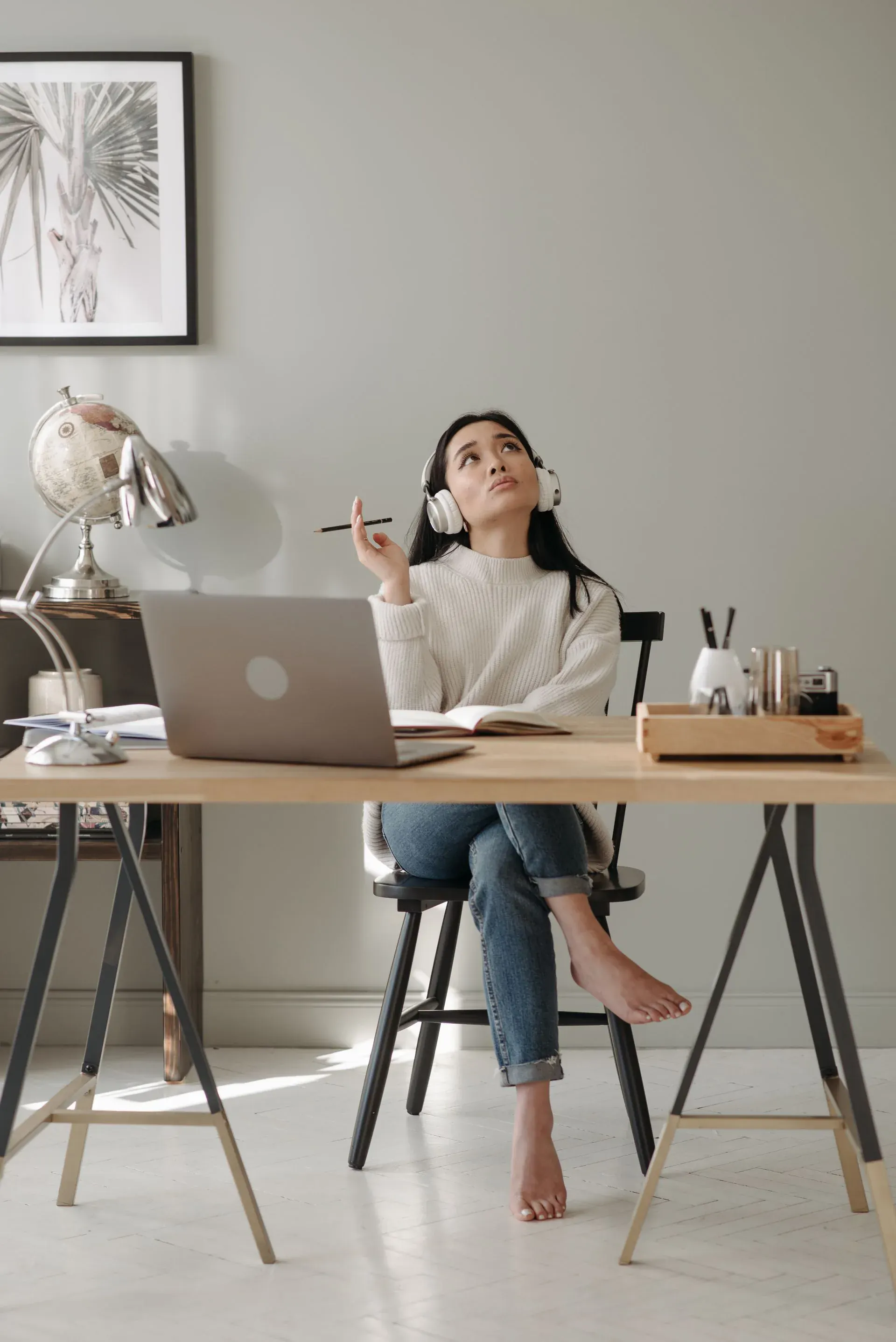 A woman pausing at her desk to look up, the small joy she nearly worked past.