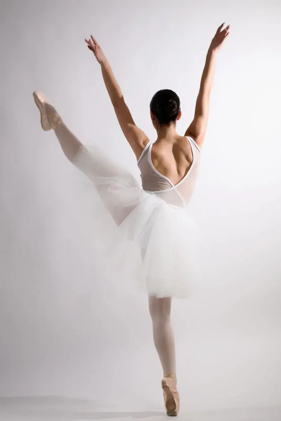 A dancer holding a pose she trained for years ago, the old version calling again.