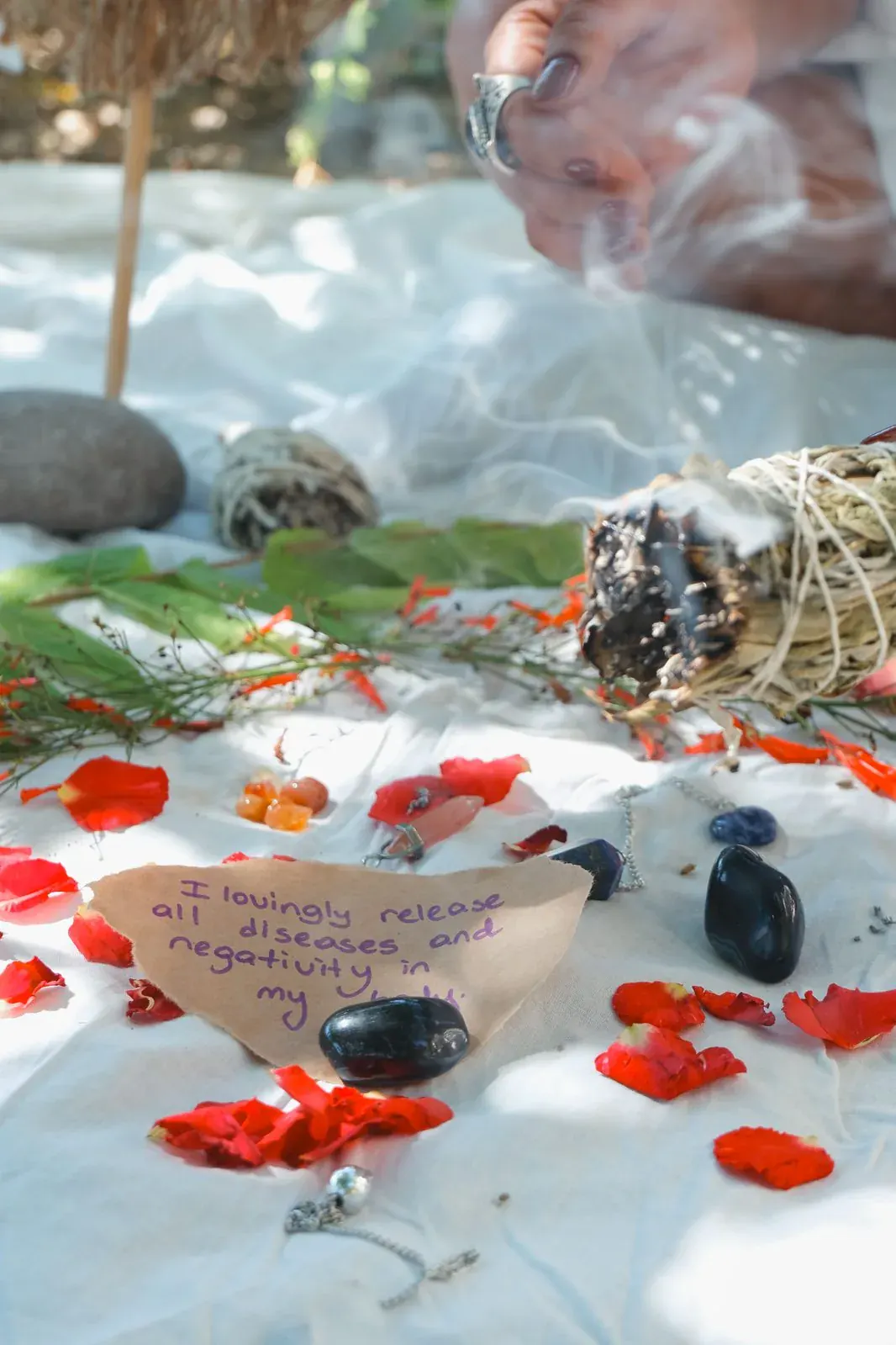 Sage, crystals and a handwritten intention among petals, three minutes kept for herself.