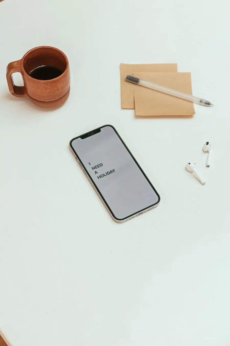 A phone laid down beside the coffee and the notebook, a boundary drawn around the scroll.