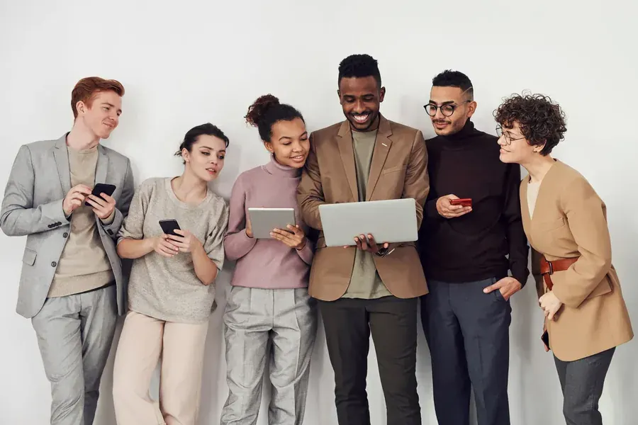 Six people holding their screens and still turned towards each other.