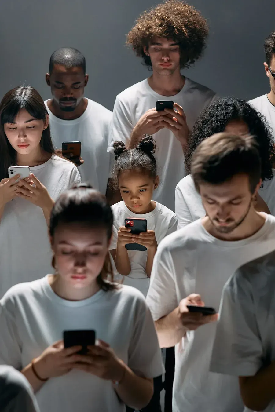 A crowd of people each lost in a phone, help that quietly became habit.