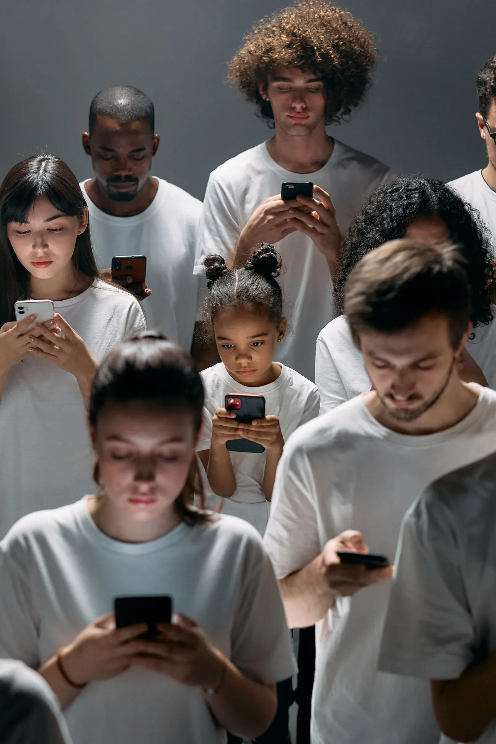 A crowd of people each lost in a phone, help that quietly became habit.