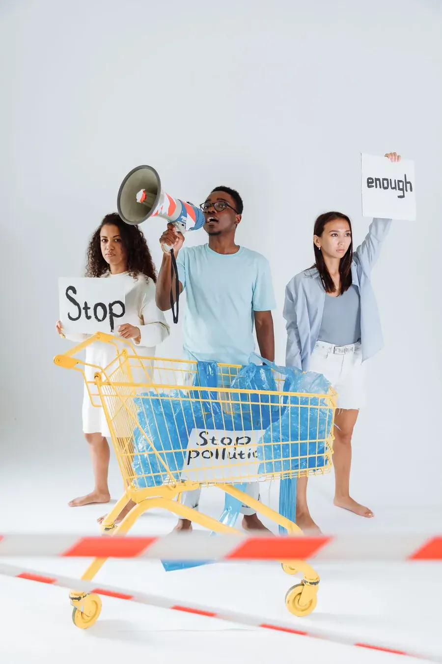 Young people at a trolley holding signs that say enough, convenience answered back.