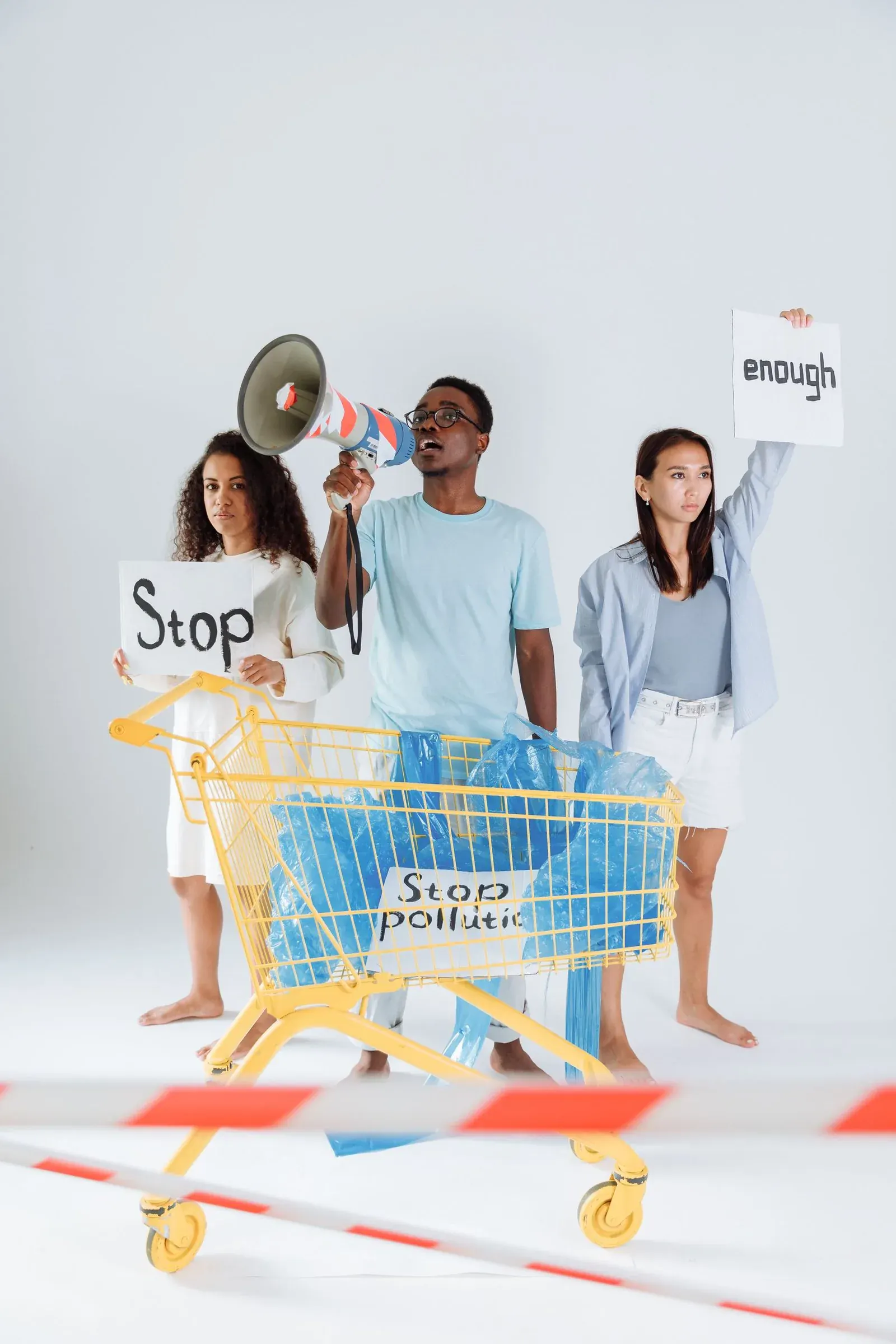 Young people at a trolley holding signs that say enough, convenience answered back.