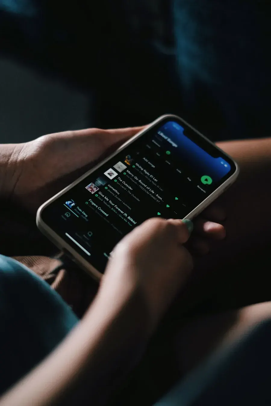 Hands scrolling in the dark, the world narrowing to what it thinks you already want.