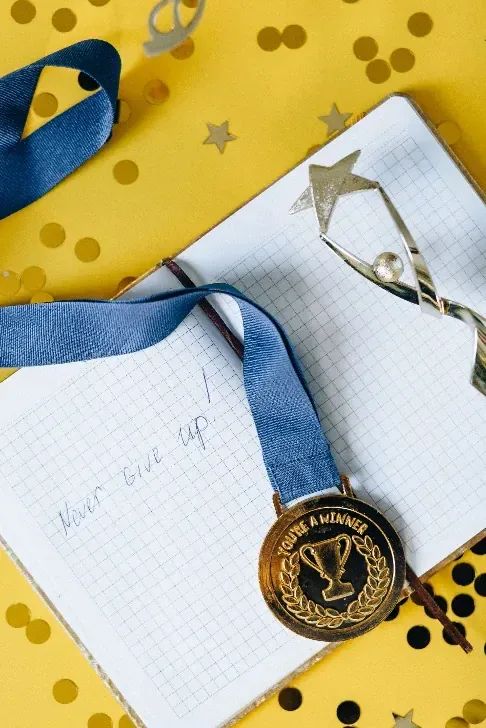 A medal lying on an open notebook, the comparison she decided not to make.