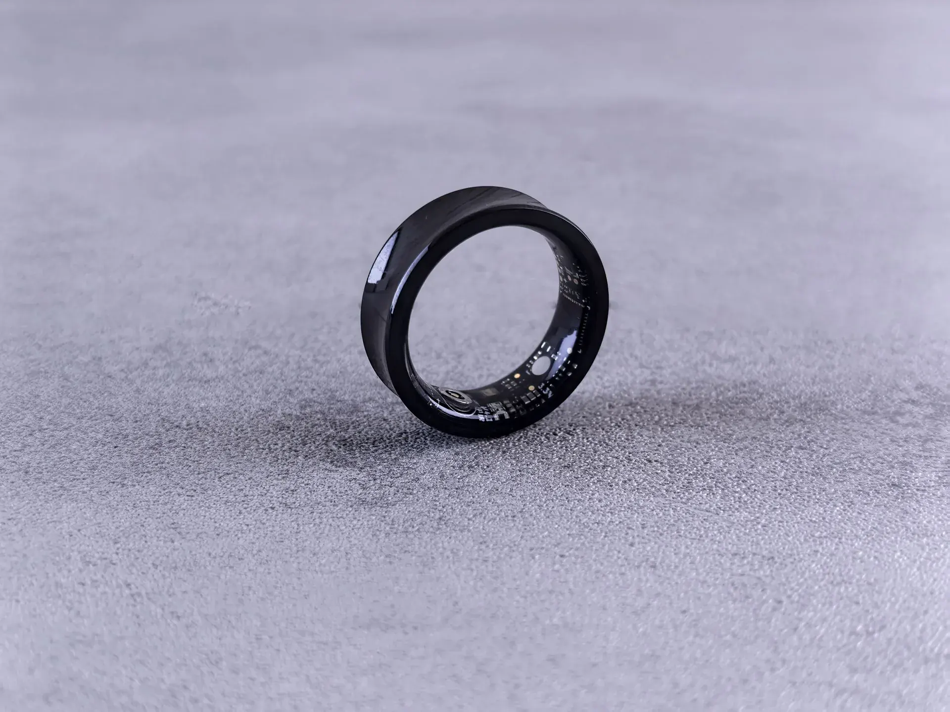 A smart ring alone on a grey surface, certain about a night it only estimated.